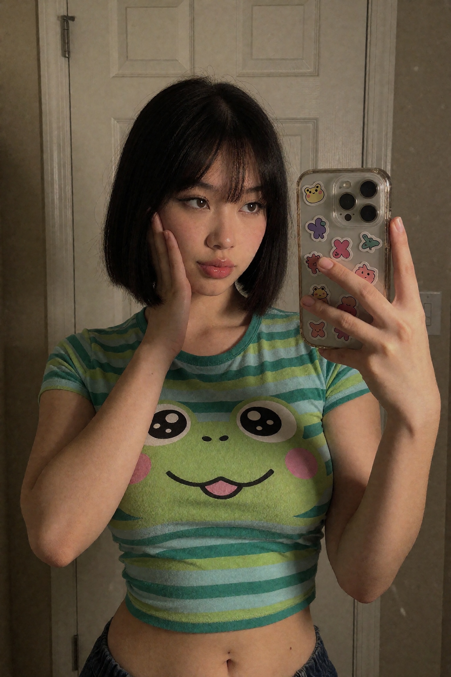 a photograph of a young Asian woman taking a selfie in a dimly lit indoor setting,  likely a bedroom or a bathroom. She ha...