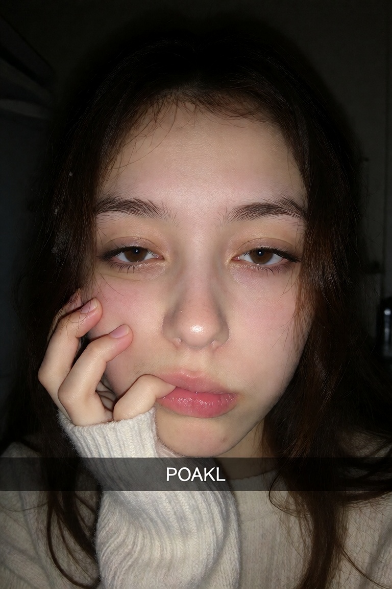 A candid ******* unflattering close-up shot of a Korean woman in her late 20s with tired eyes and messy hair clipped loose...