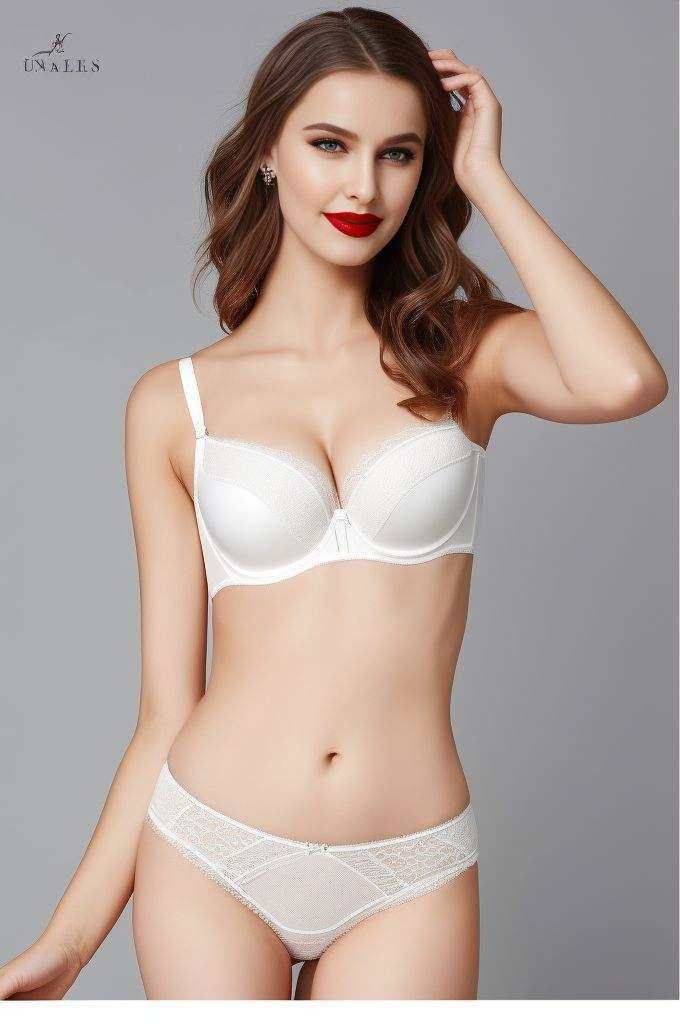 <lora:supercutelingerie:0.7>, The woman is wearing a white bralette with lace detailing and sheer panels. Her hair is tied up into an elegant bun, while her lips are painted red to match her lipstick. The model's pose suggests confidence and sensuality.