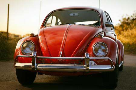 analog gloomy photo of a (red) Volkswagen Beetle car,  ,  dark sunset on Tensor.Art
