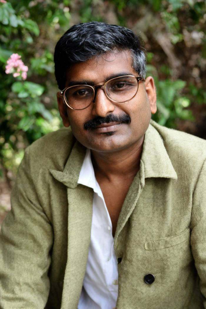 photo of a man,  Indian,  round glasses on Tensor.Art