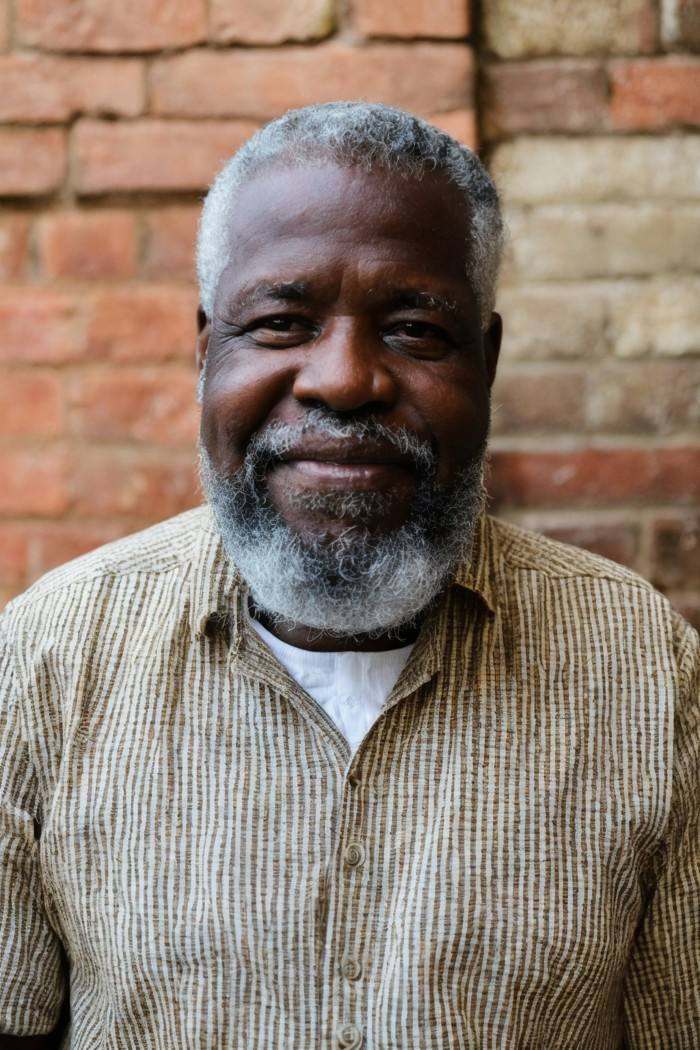 photo of a man,  Haitian,  middle-aged with graying beard on Tensor.Art