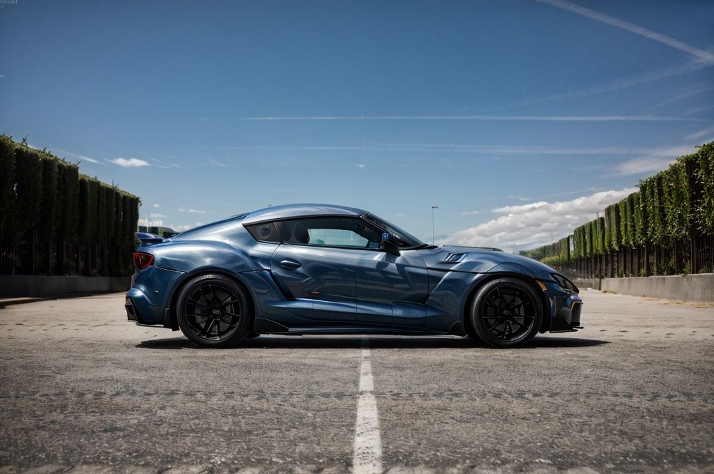 Supra A captivating image of a Supra,  its sleek silhouette painted in a mesmerizing pearlescent dark blue. The photo show...