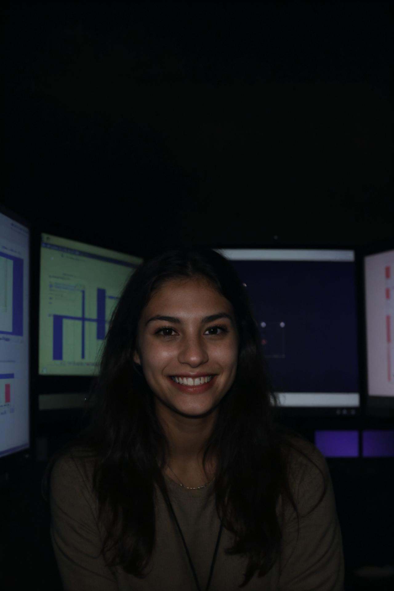 A female social worker having fun in a dark room surrounded by computer screens,  poor quality photo,  blurry on Tensor.Art