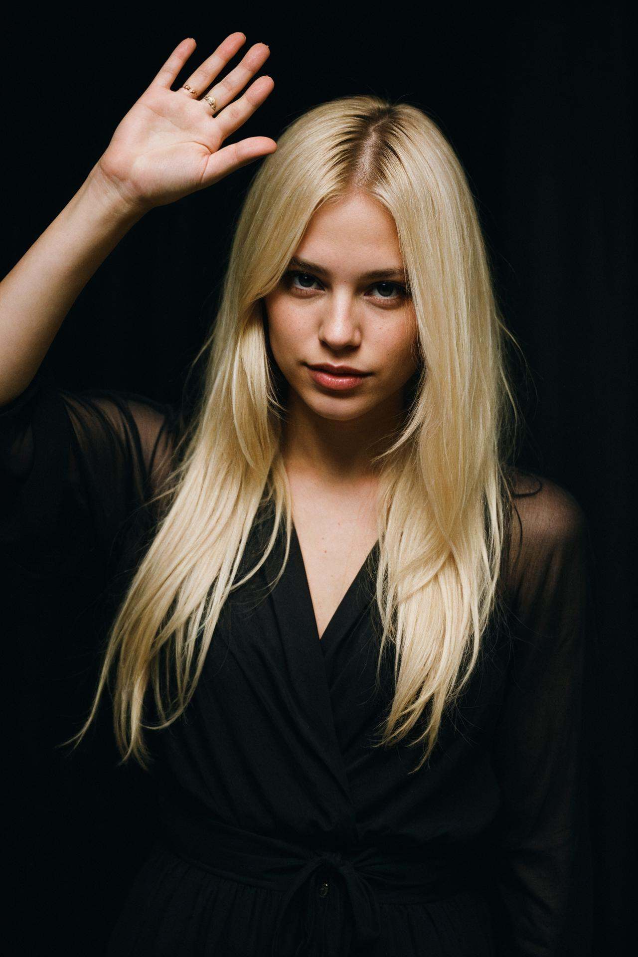 blond female in a dark theme waving goodbye on Tensor.Art