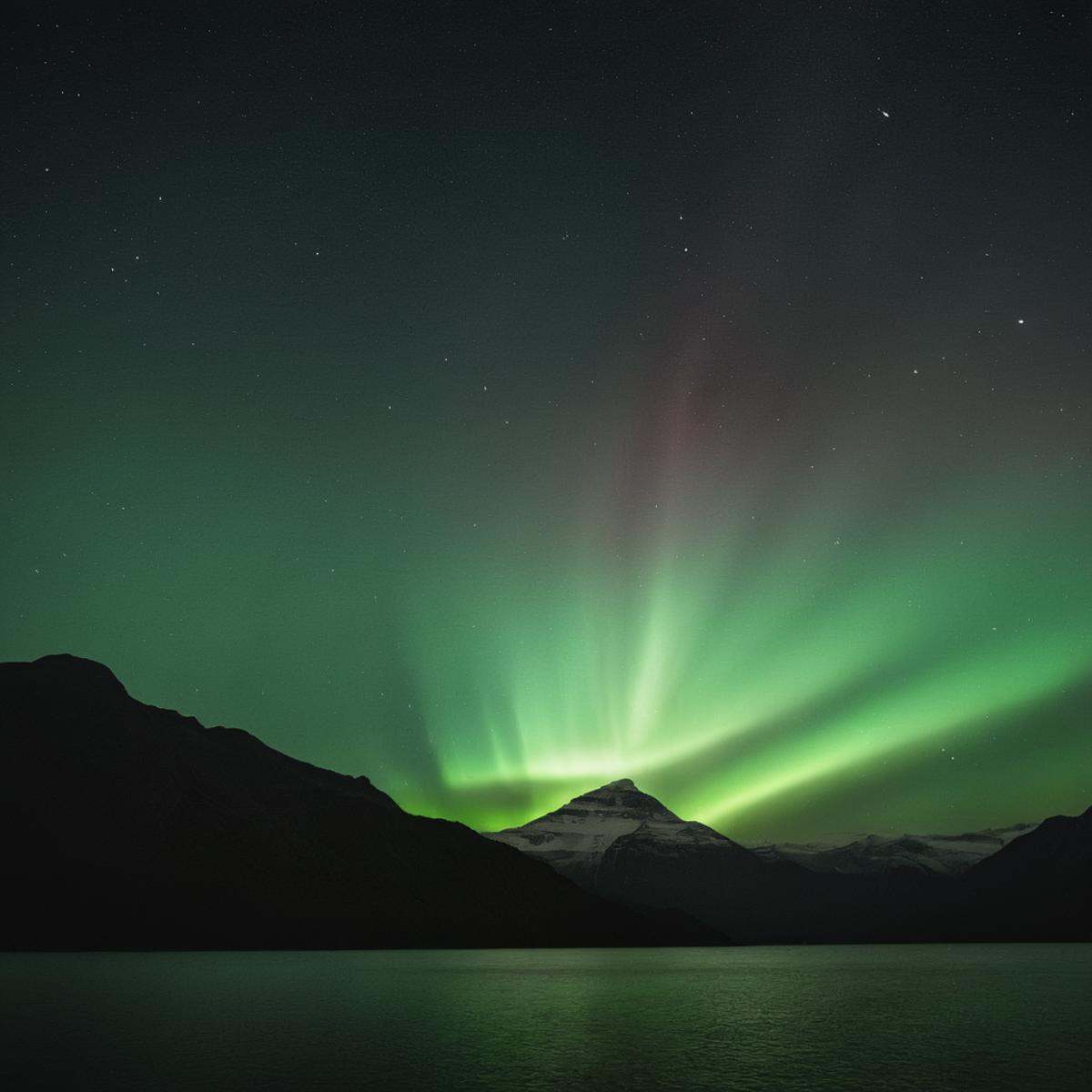 cinematic film still of volumetric lighting stylea mountain with a green aurora bore in the sky,  outdoors,  sky on Tensor...