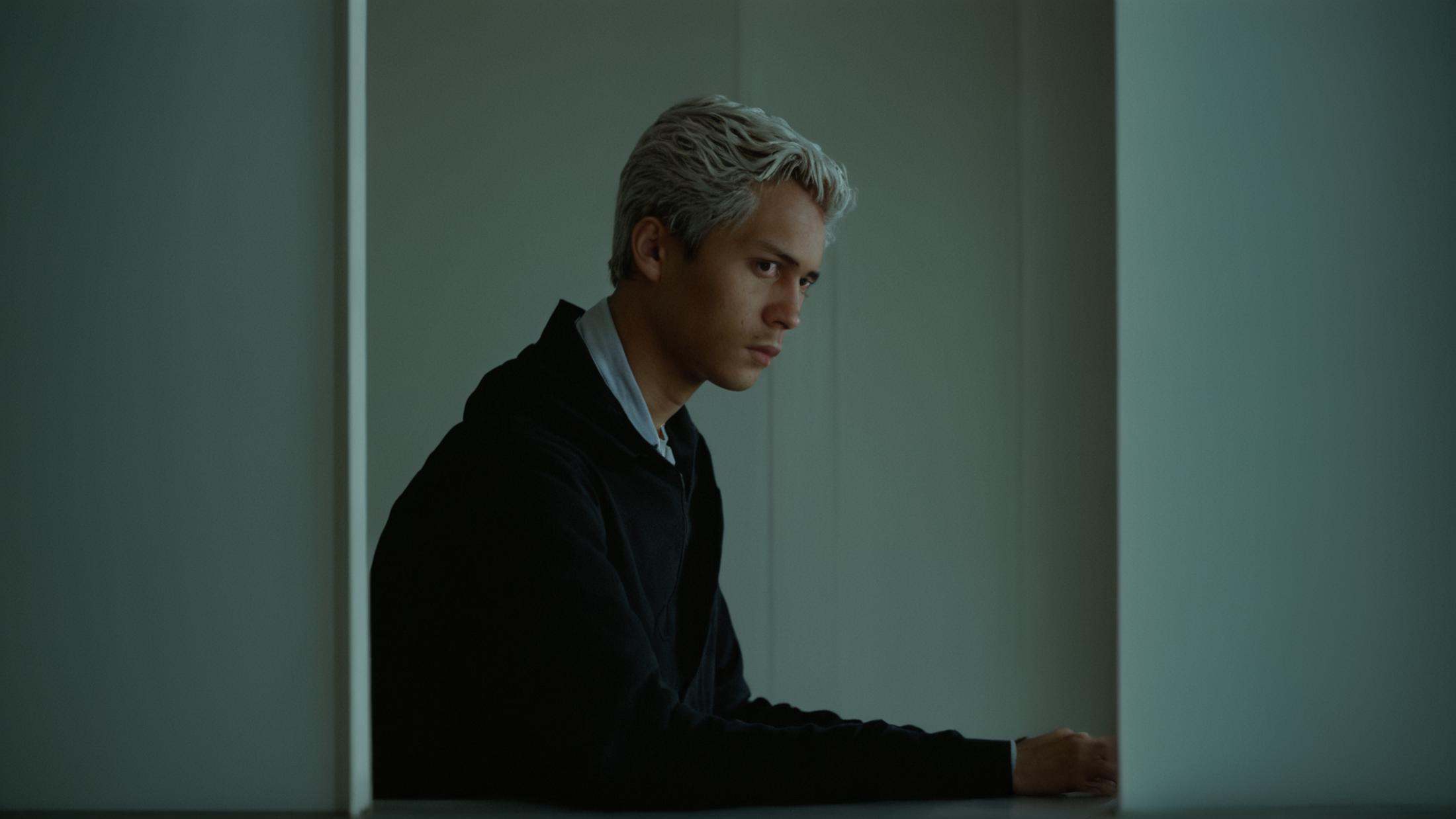 cinematic film still of a man leaning out of a window with his hand on his chin,  solo,  short hair on Tensor.Art
