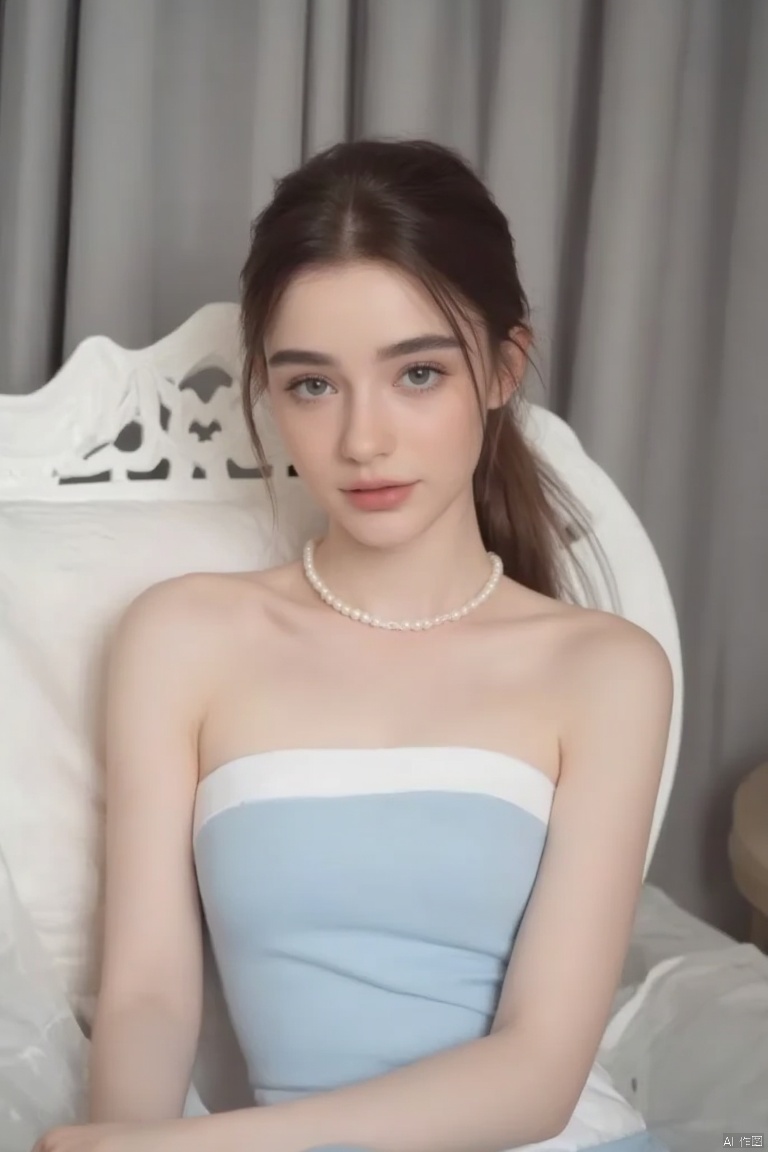 a young europe woman is seated on a white chair. She is wearing a light blue strapless dress with a white stripe down the center of her chest. Her hair is pulled back in a ponytail, and her eyes are a piercing blue. She has a pearl necklace around her neck, adding a touch of charm to her outfit. The backdrop is a gray curtain, and a white pillow is behind her.