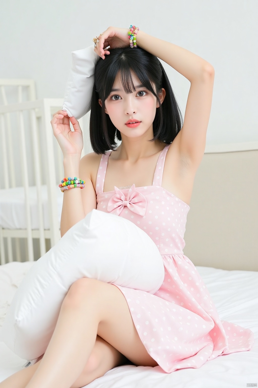 a young Asian woman is seated on a white bed with her legs crossed. She is dressed in a light pink sleeveless dress with a pink bow at the neckline, adorned with white polka dots. Her hair is styled in a sleek bob, and her bangs are adorned with colorful bracelets. Her eyes are a piercing blue, and she has a serious expression on her face. Her left hand is raised above her head, while her right hand is holding a white pillow. The backdrop is a stark white wall, and a white crib can be seen in the background.