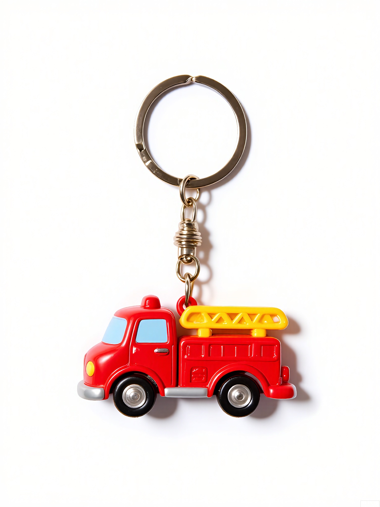 WOGJ,
Photograph of a tiny red fire truck keychain with rubber wheels, a silver ladder, and a smiling face on the windshield. The truck hangs from a fire-hydrant-shaped clasp against a crisp-white background, perfect for a nostalgic touch.
