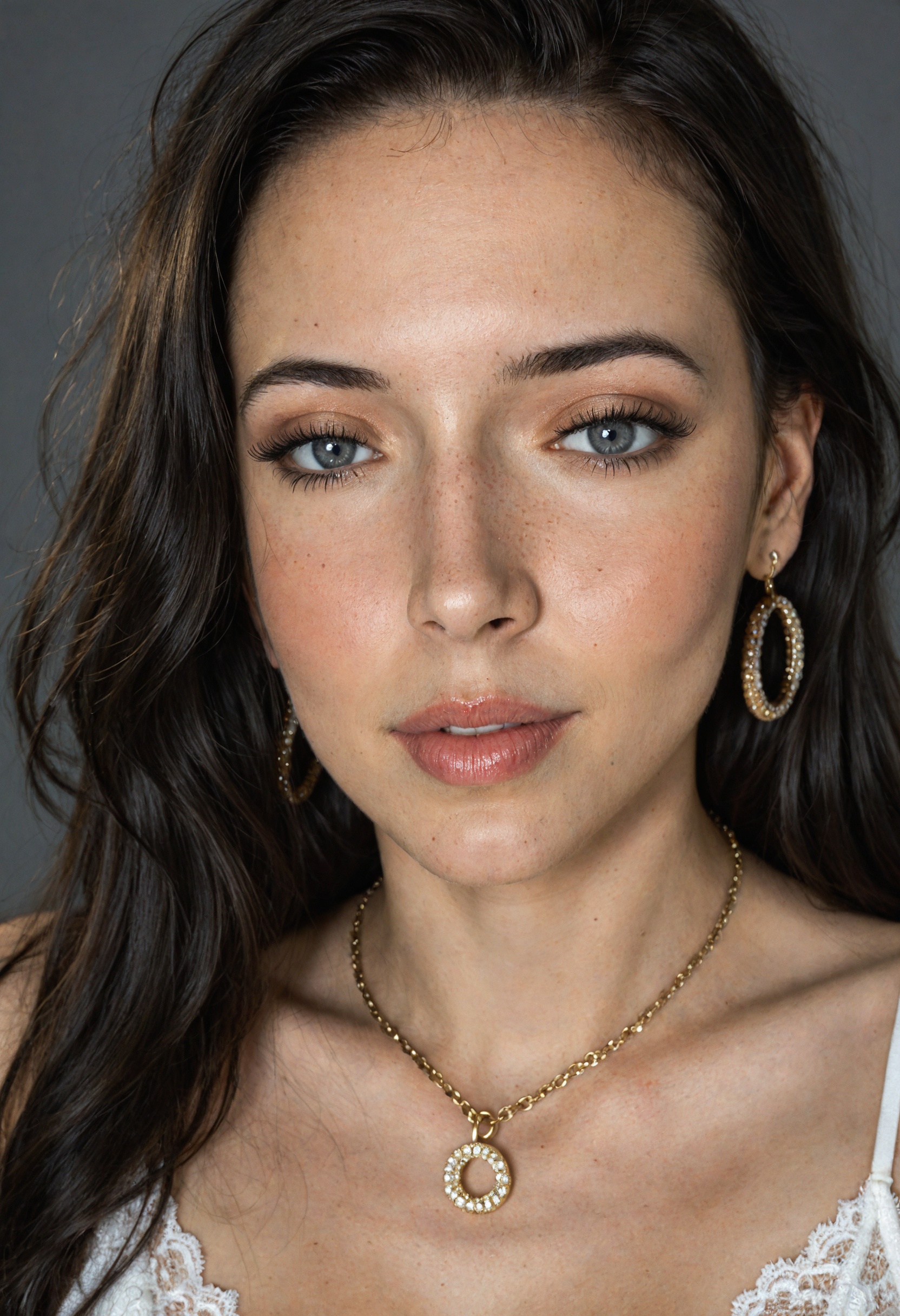 It is gray background and the light from the upper-left side falls on the half side of her face. The light isn't too brigh...