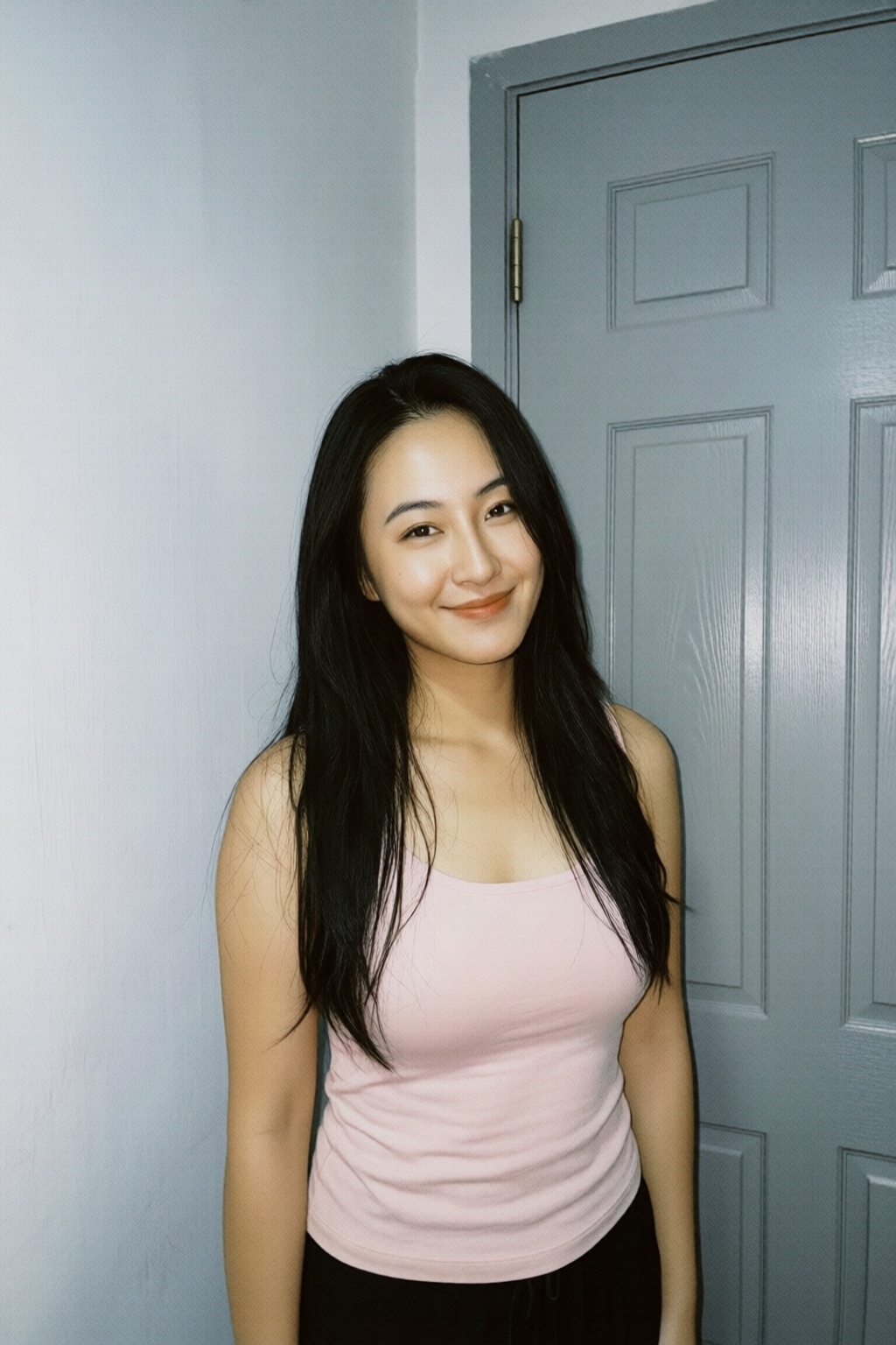 Photograph of an Asian woman with long,  straight black hair and fair skin. She has a slim physique with medium-sized brea...