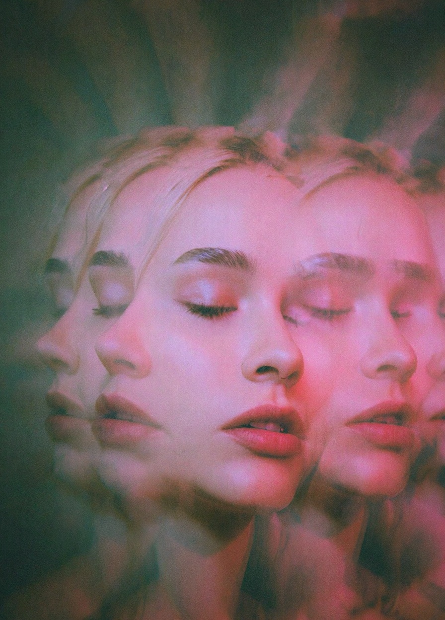 The image is a photograph with a psychedelic,  surrealistic quality,  featuring a close-up of a woman's face with multiple...