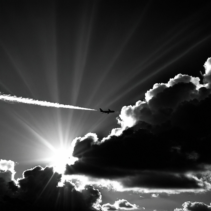 Dark Moody Atmosphere,  Dark Cinematic Chiaroscuro Lighting Style of a plane flying through a cloudy sky with sun rays com...