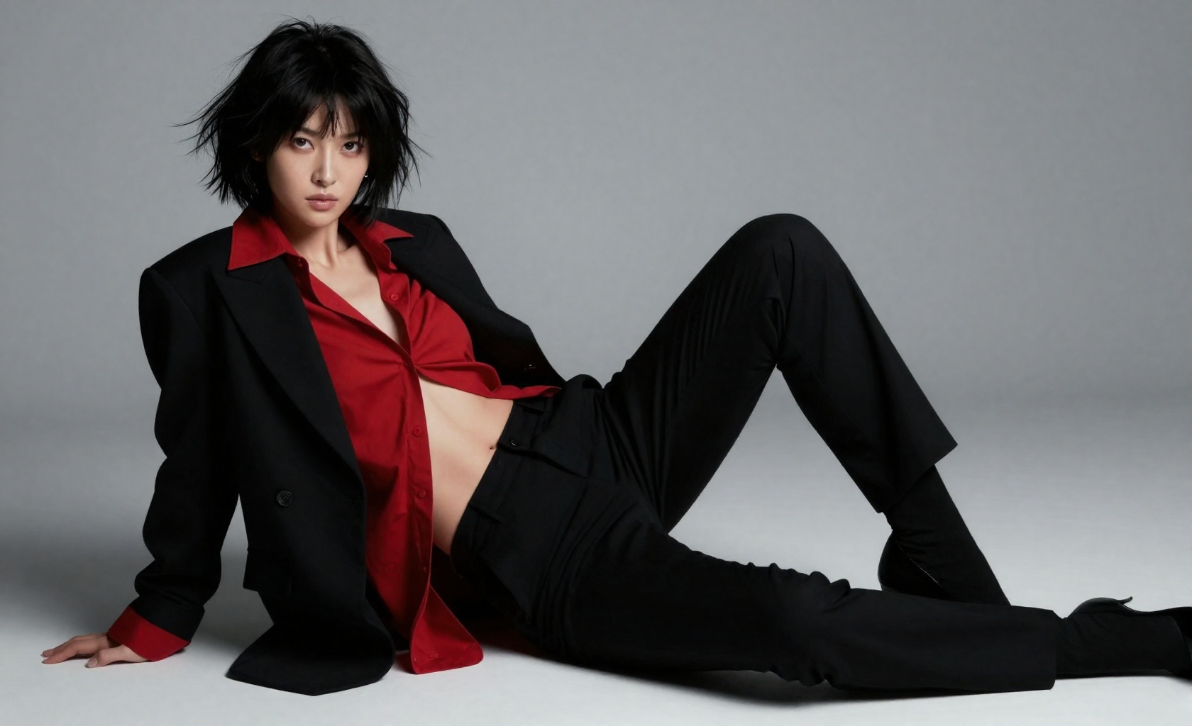 high-fashion editorial portrait of a striking 20yo woman with a messy tousled jet-black chin-length bob haircut,  reclinin...