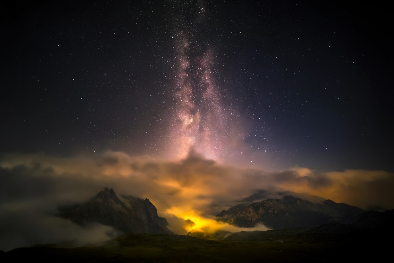 aurelmanea3z photography. A nighttime landscape with a prominent view of the Milky Way stretching across the sky. The Milk...