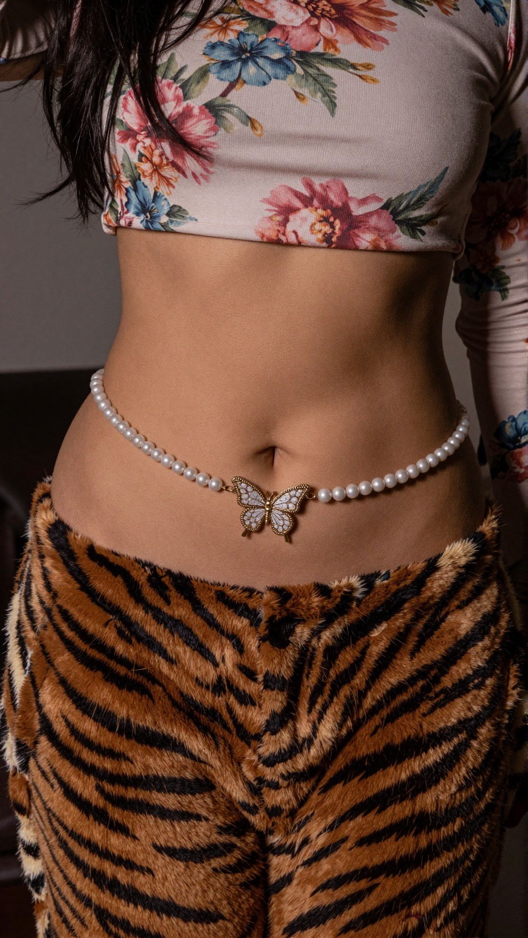 Photograph of a woman's midsection,  focusing on her flat,  toned stomach. She is wearing a floral-patterned on Tensor.Art