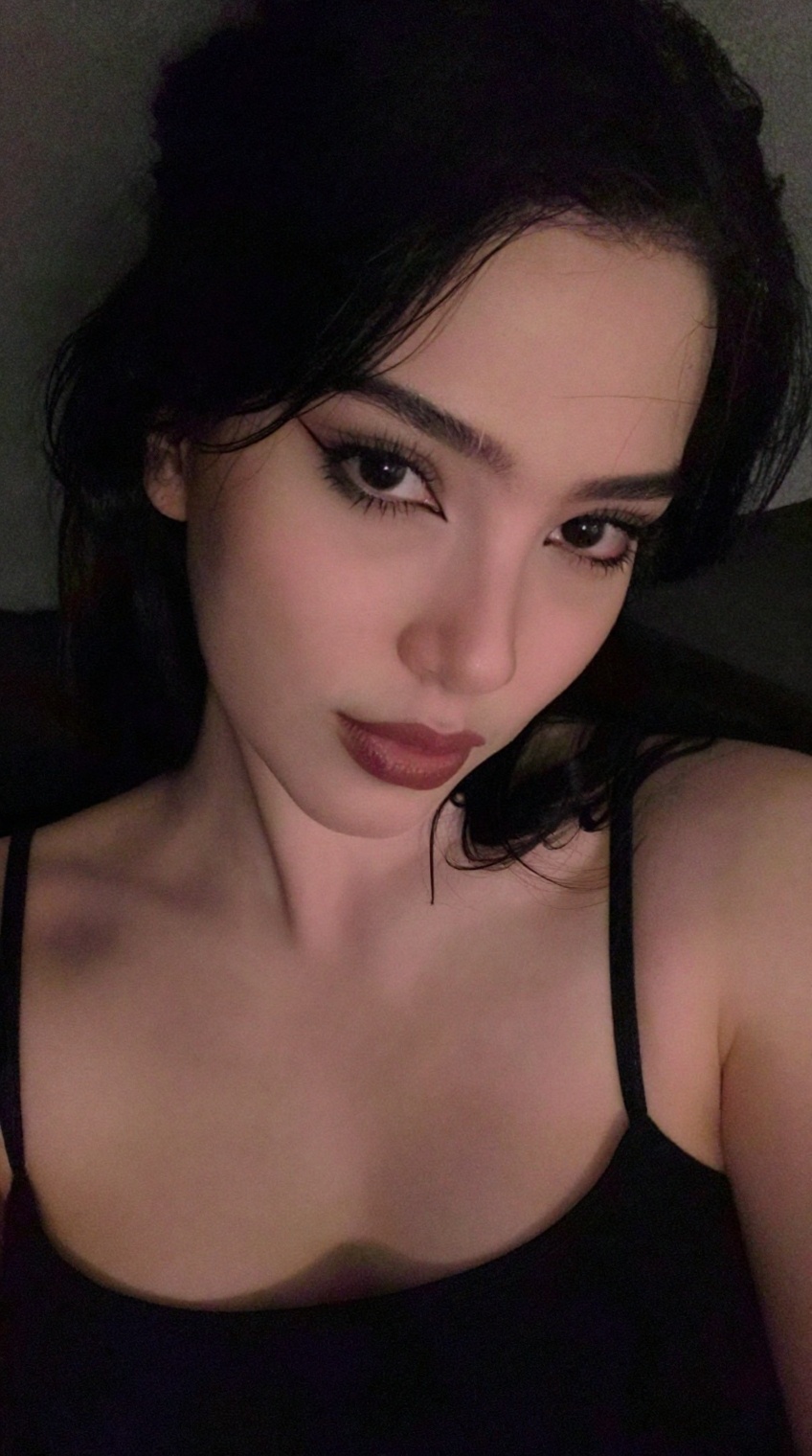 taken_by_ph0ne,  low light mobile photo,  close up. A stunning Caucasian woman with dyed jet black hair and a pale complex...
