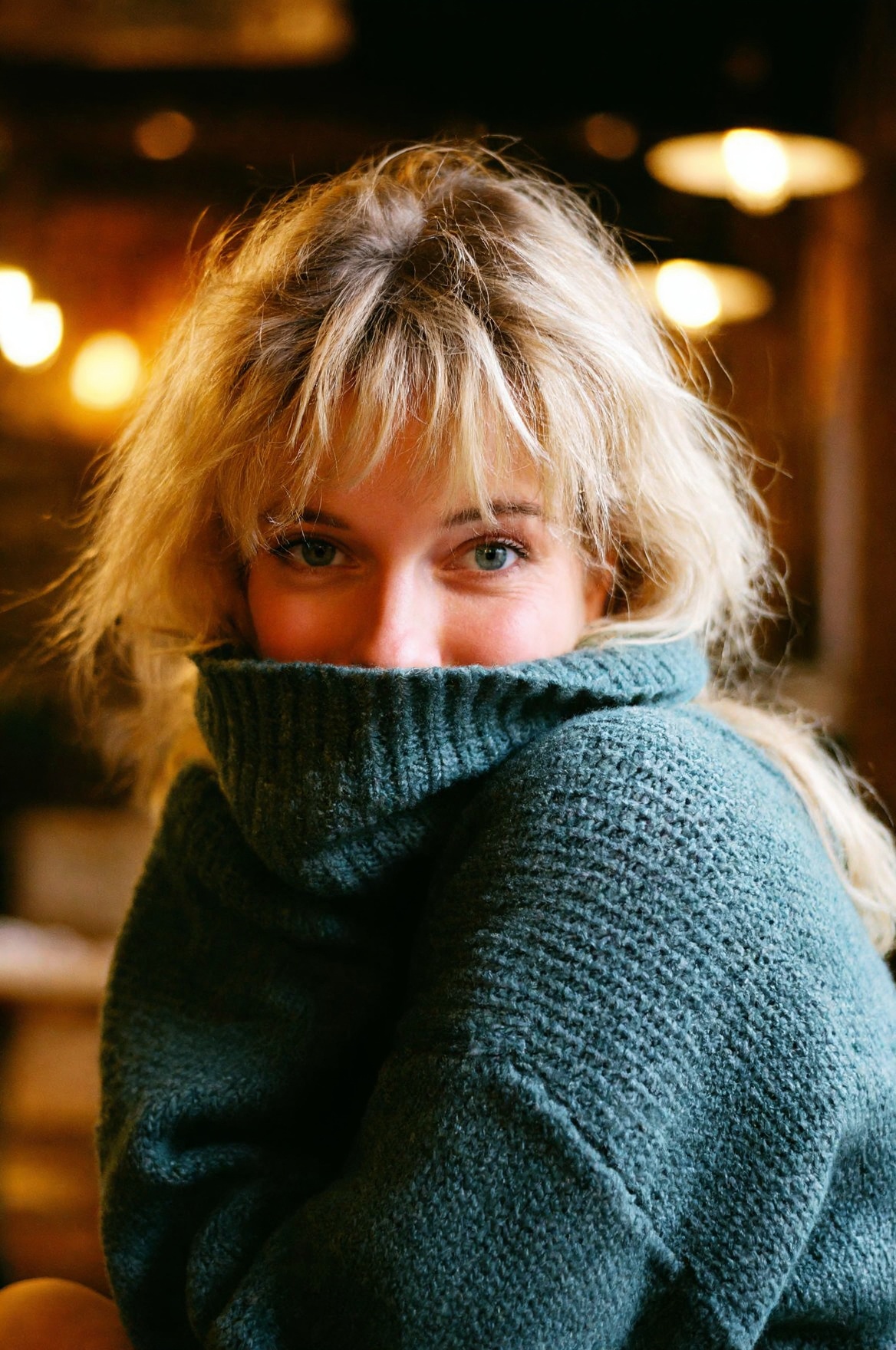 SUBJECT: woD4n1,  blonde woman with messy textured bangs CLOTHING: oversized knit sweater collar pulled up near chin ACCES...