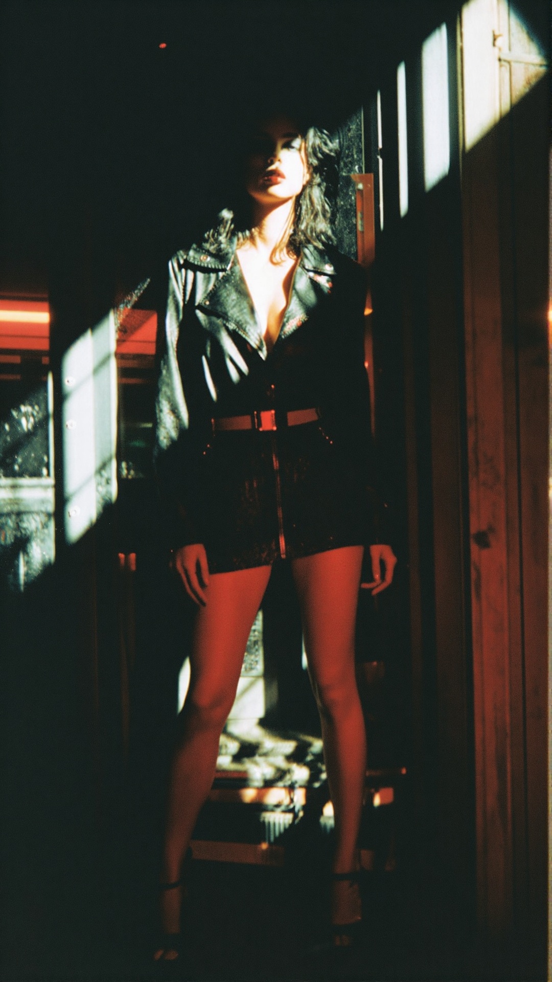Create a photorealistic fashion photography scene featuring a femme fatale character standing confidently in a stark,  all...