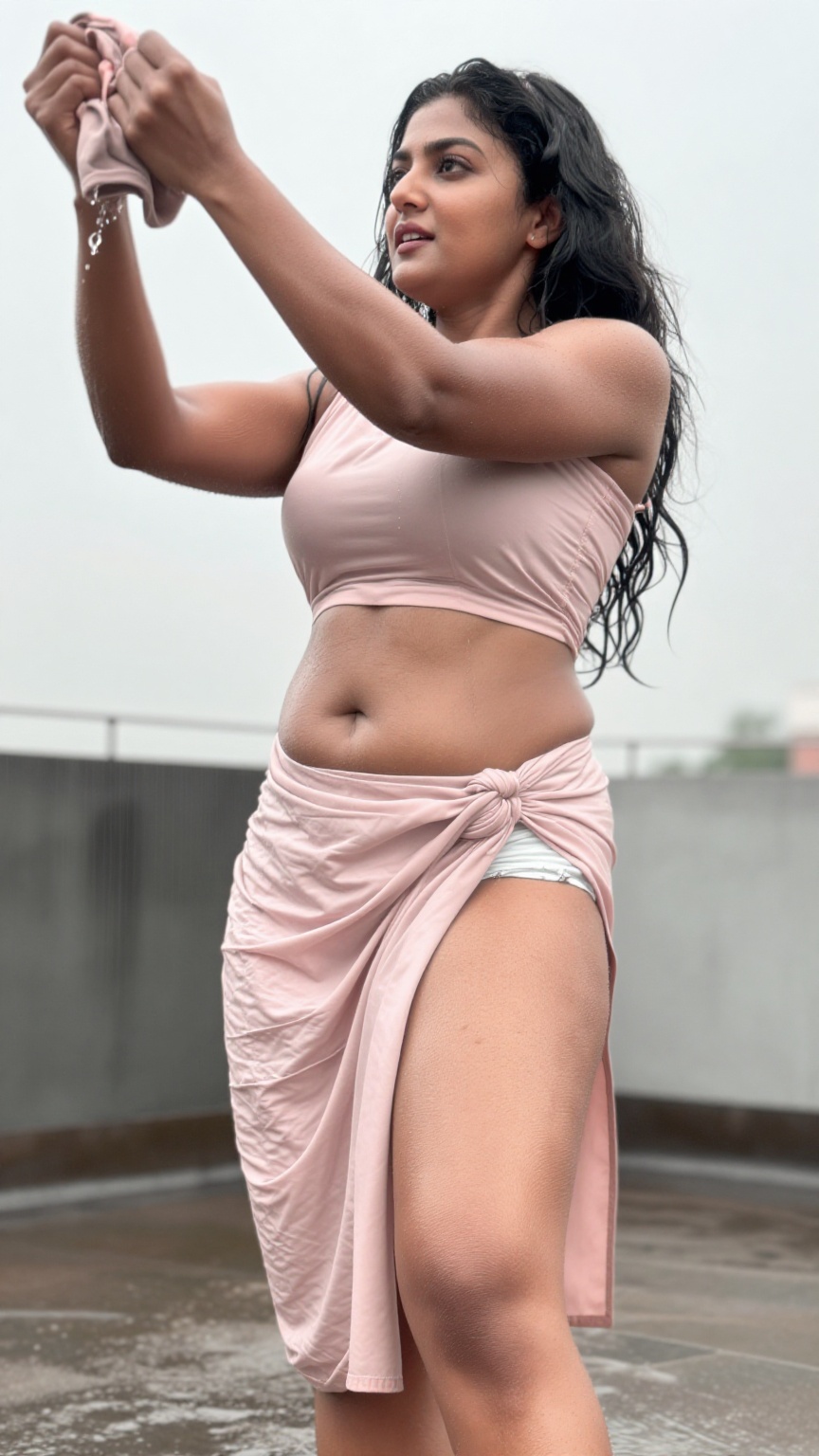 A young South Asian woman with fair skin and a strong muscular fit body stands on a rainy rooftop captured in a low angle...