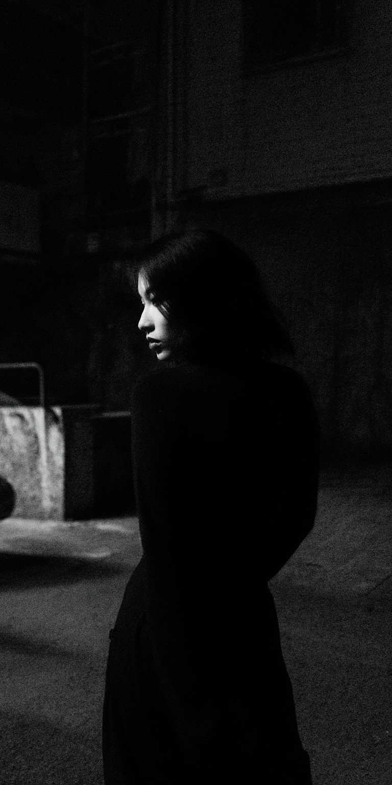 A slow,  deliberate turn of the woman's head to the left dominates the frame,  capturing a dark and mysterious atmosphere....