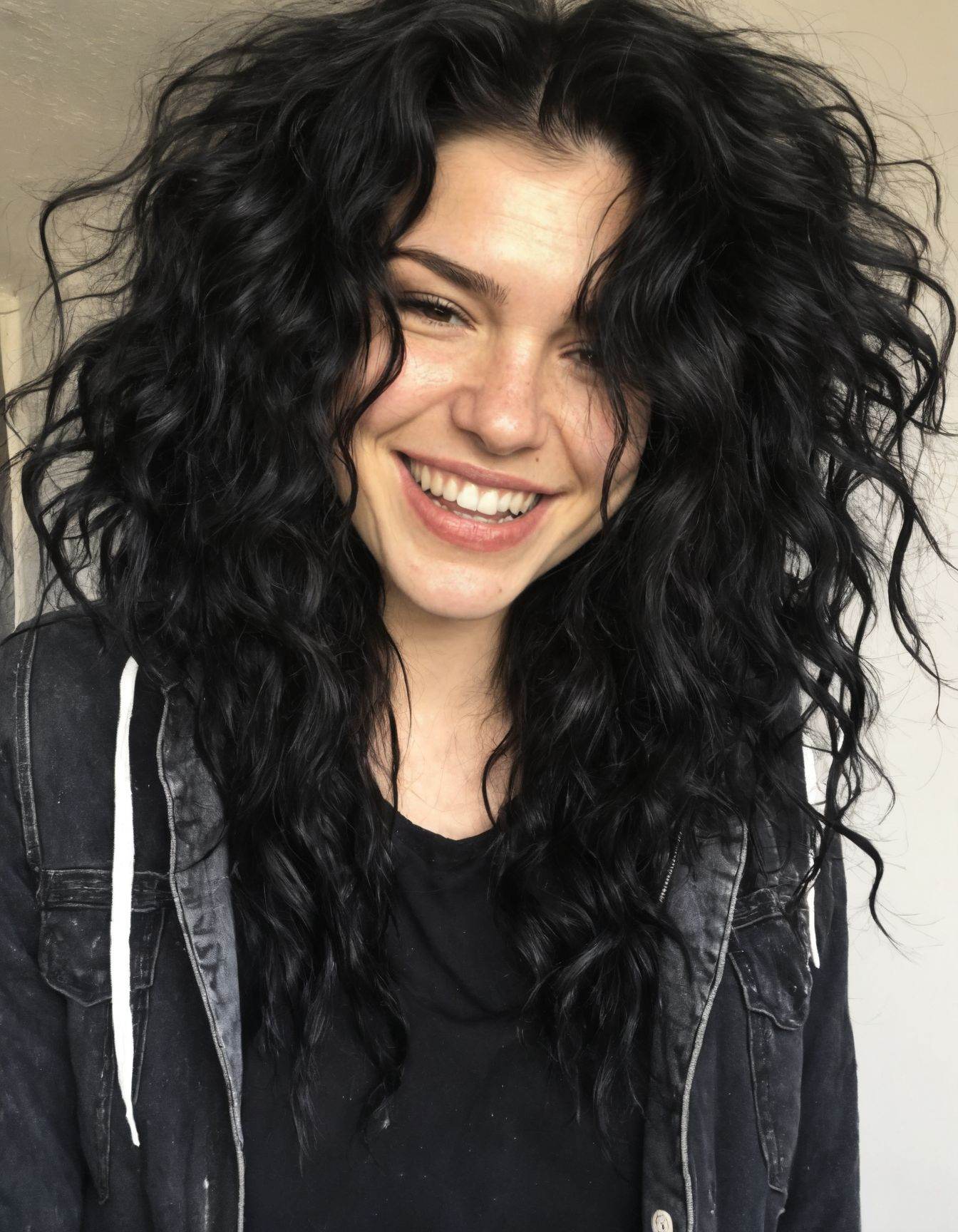 A photo of a girl with black messy wavy hair give her fangs and a wide smile give her a grunge inspired outfit,  realistic...