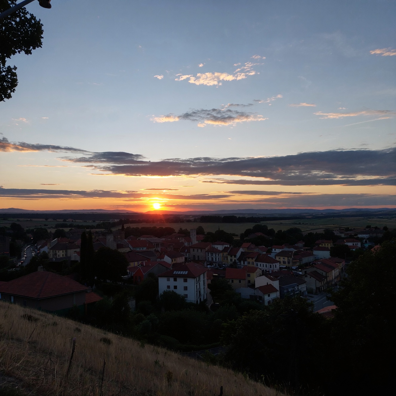 ******* photo. a sunset over a town on Tensor.Art