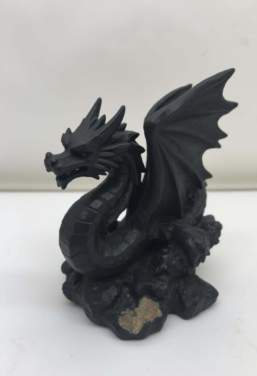 The image is a photograph of a small,  intricately detailed coal statue of a dragon. on Tensor.Art