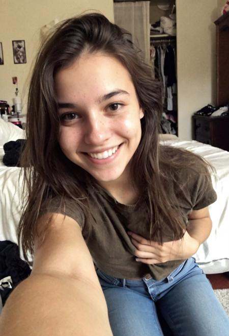 Authentic share,  ******* selfie,  A 22 year old Italian girl wearing jeans and a casual top. She is smiling casually on T...