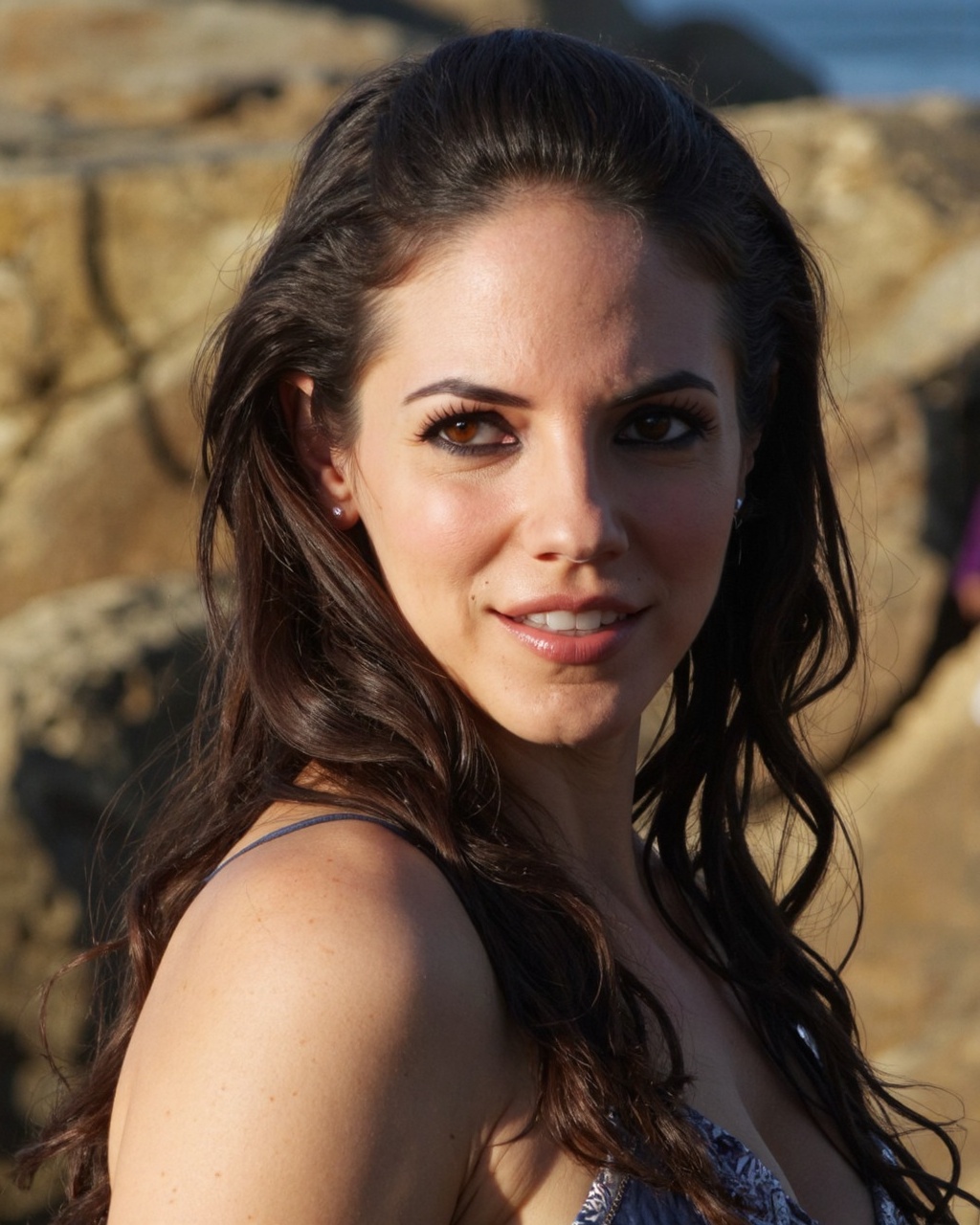 A high-resolution photograph of anna_silk with striking brown eyes,  set against a natural,  rugged coastal background. Sh...