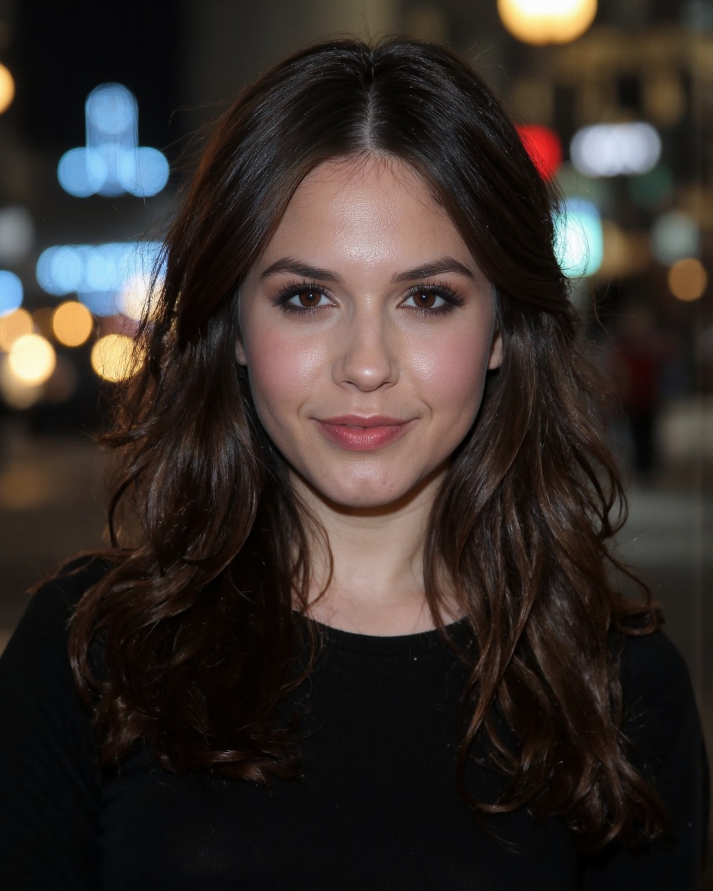 A portrait of erin_sanders with long,  straight brown hair,  set against a blurred city street at night. Bright blue and y...