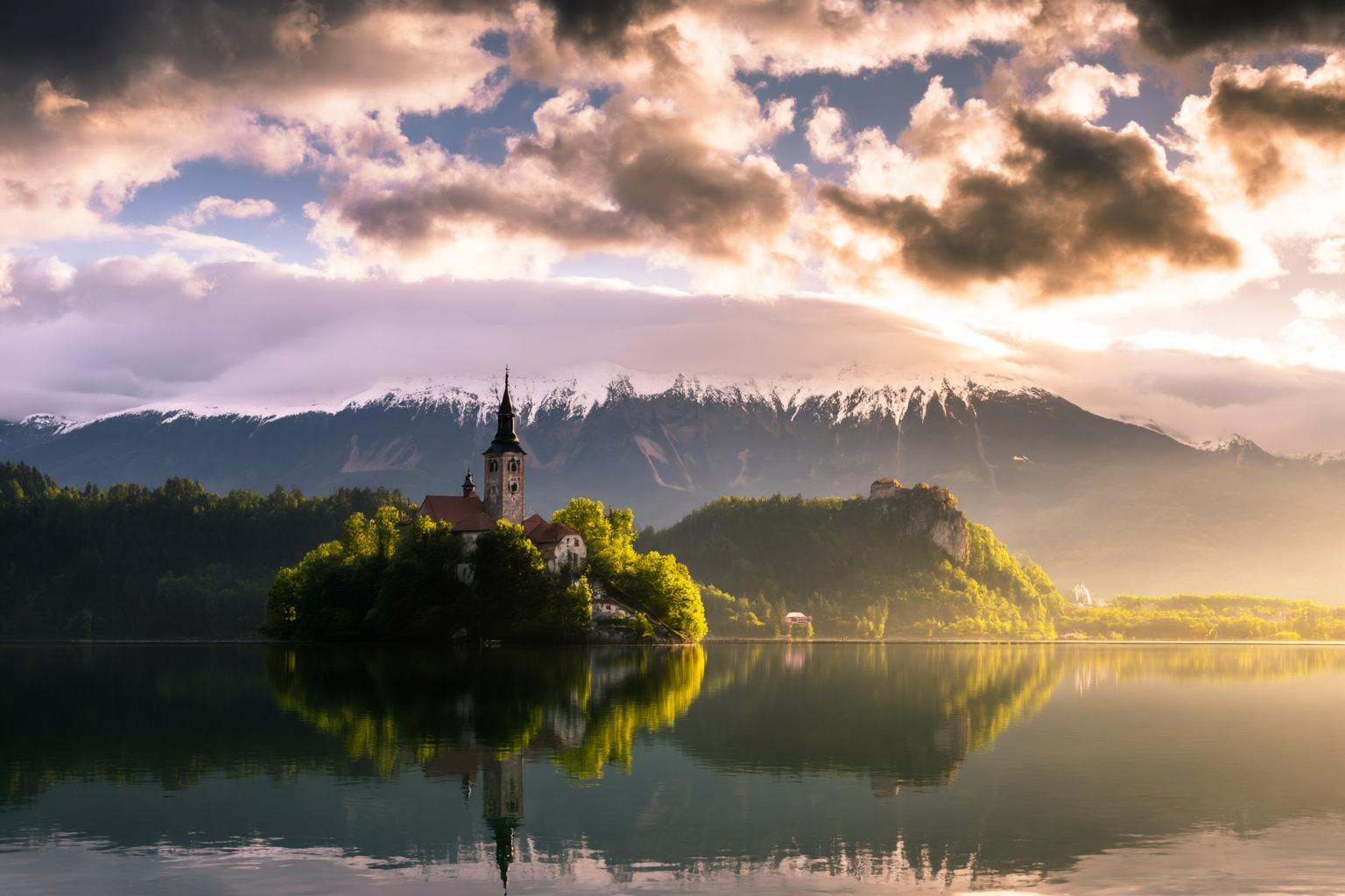 aurelmanea2q photography. A and picturesque landscape with a small island in the middle of a calm lake. The island is cove...