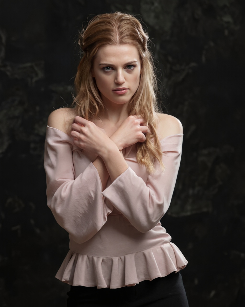 A portrait of katie_mcgrath with blonde hair styled in a half-up,  half-down braid. She wears a soft pink off-the-shoulder...