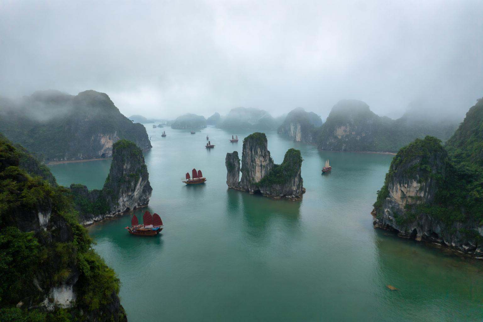 aurelmanea2q photography. An ethereal and atmospheric coastal landscape view of Ha Long Bay in Vietnam. The scene is domin...