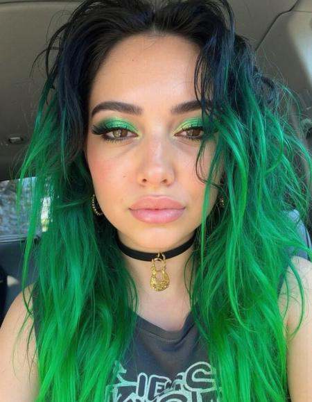 br12ght A bright photo of a woman with striking black and green hair snaps a bold selfie,  her vibrant strands cascading a...