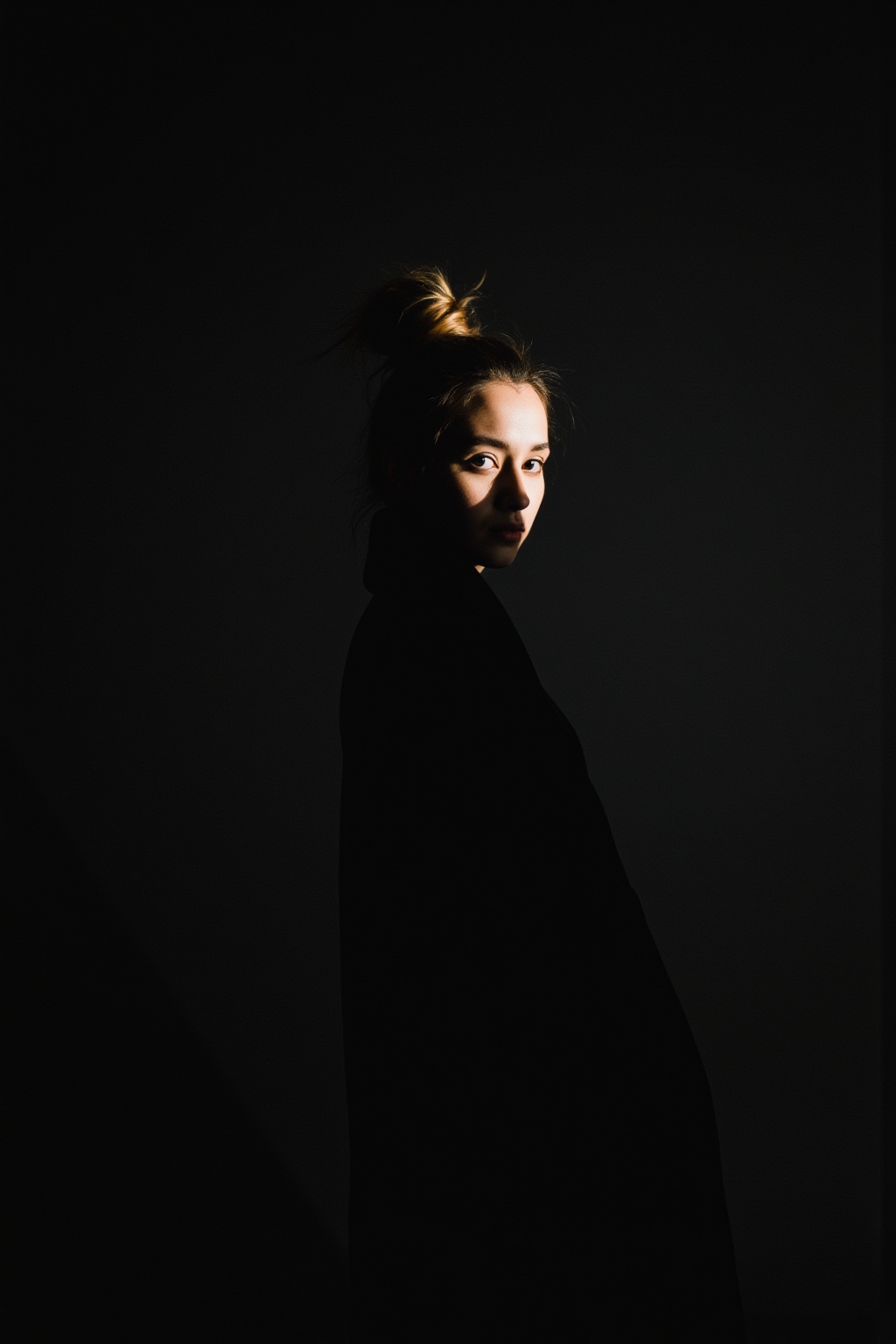 film grain,1girl,spotlight,silhouette,parted lips,looking at viewer,monochrome,portrait,deatailed beautiful face,hair bun,simple background,dark background,light master,film grain,
