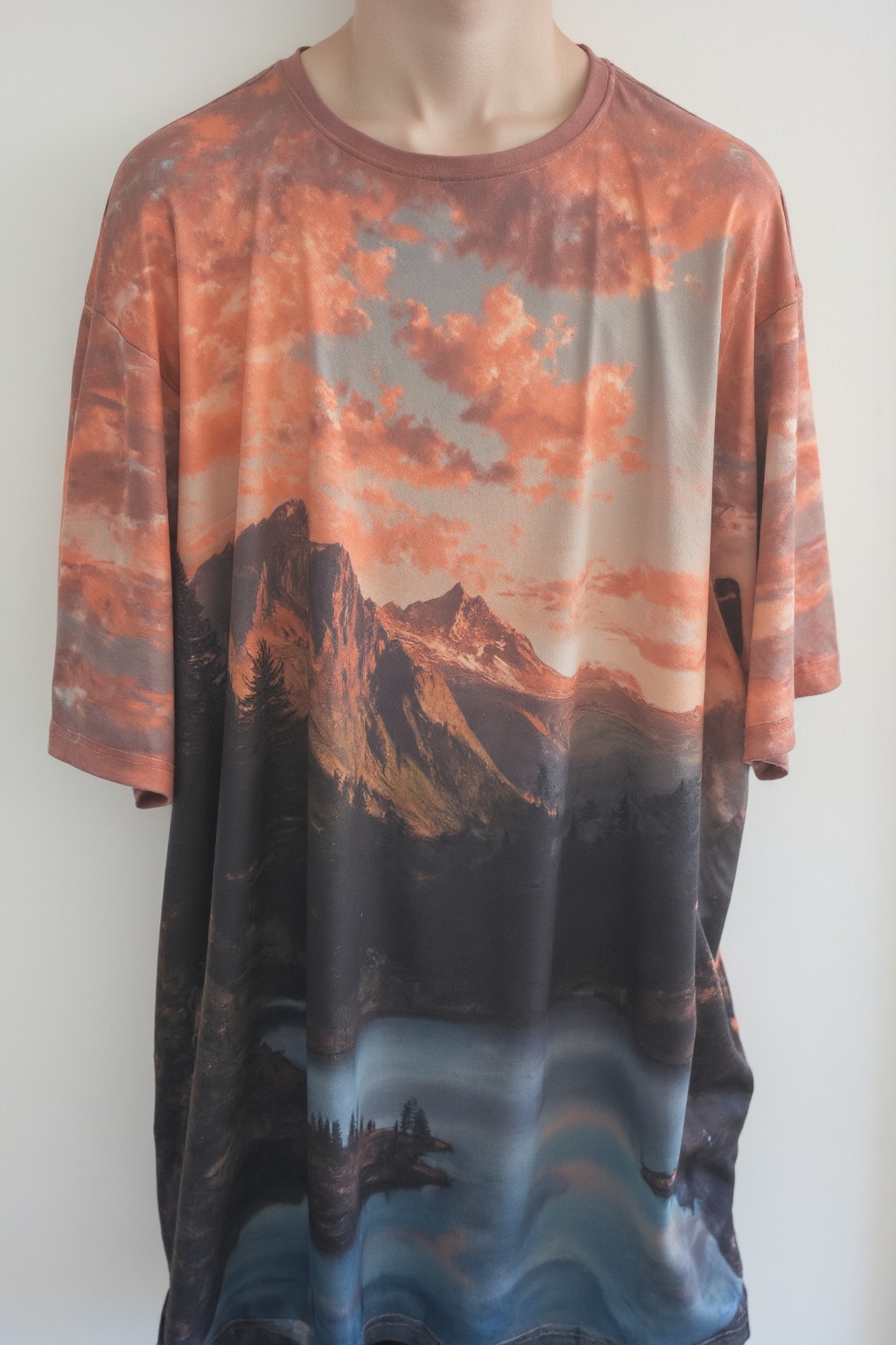 T_shirt with a Design(pic of a magnificent sunset over a mountainous landscape,  where the high peaks are bathed in a gold...