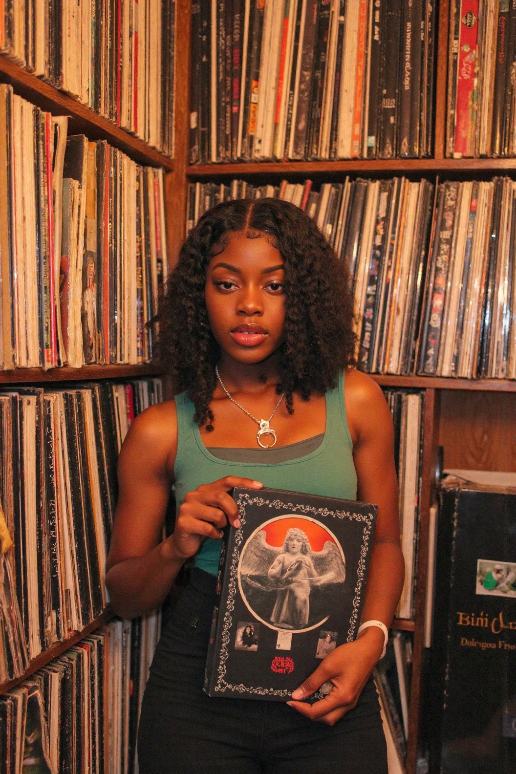 Create an image where a person stands in a room brimming with a vast collection of vinyl records. They hold a book with a...