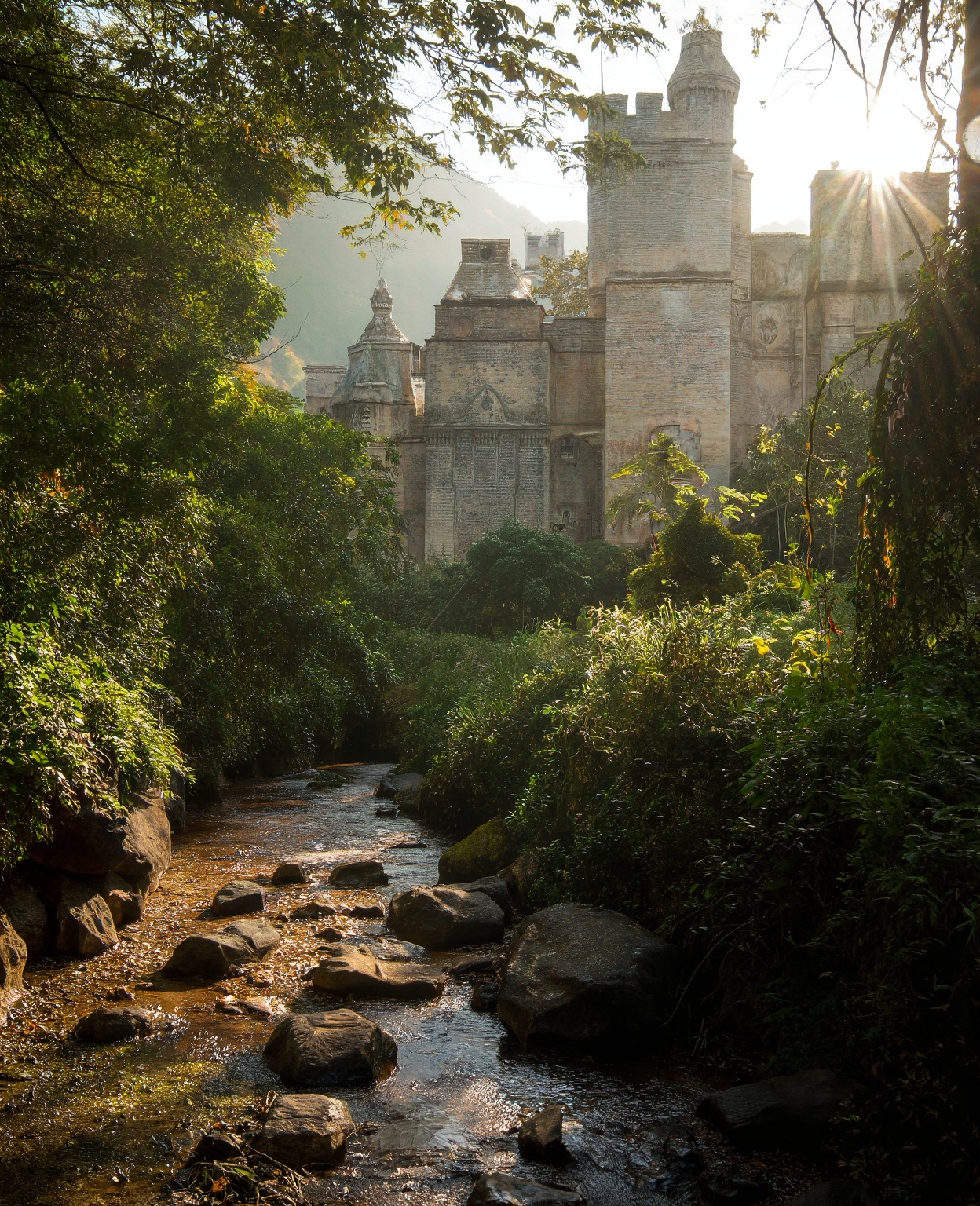 A majestic medieval castle stands tall amidst a serene and tranquil atmosphere,  surrounded by a gentle stream meandering...