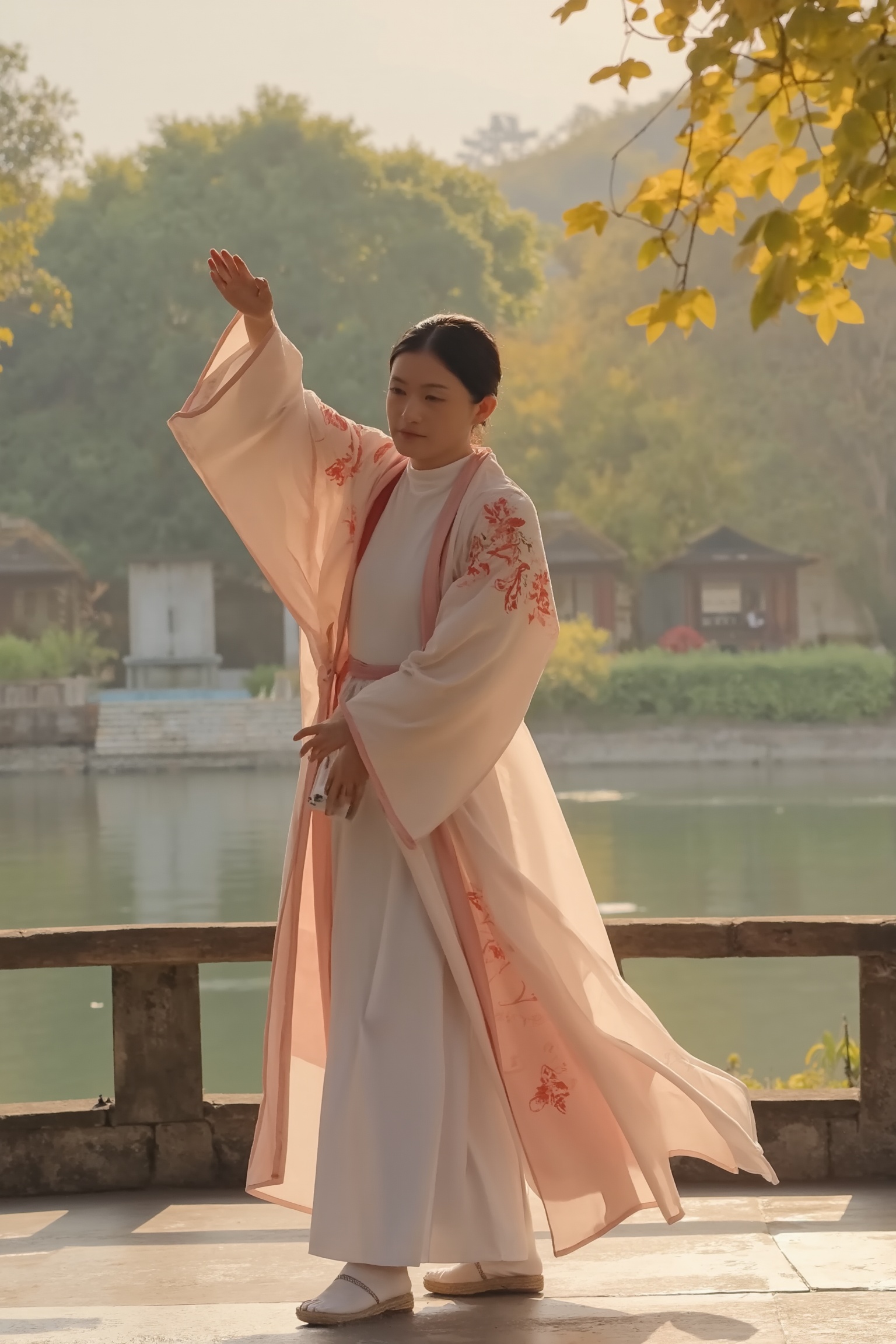 A beautiful woman in a traditional Chinese hanfu,  standing on a riverbank park in the early morning,  performing a gracef...