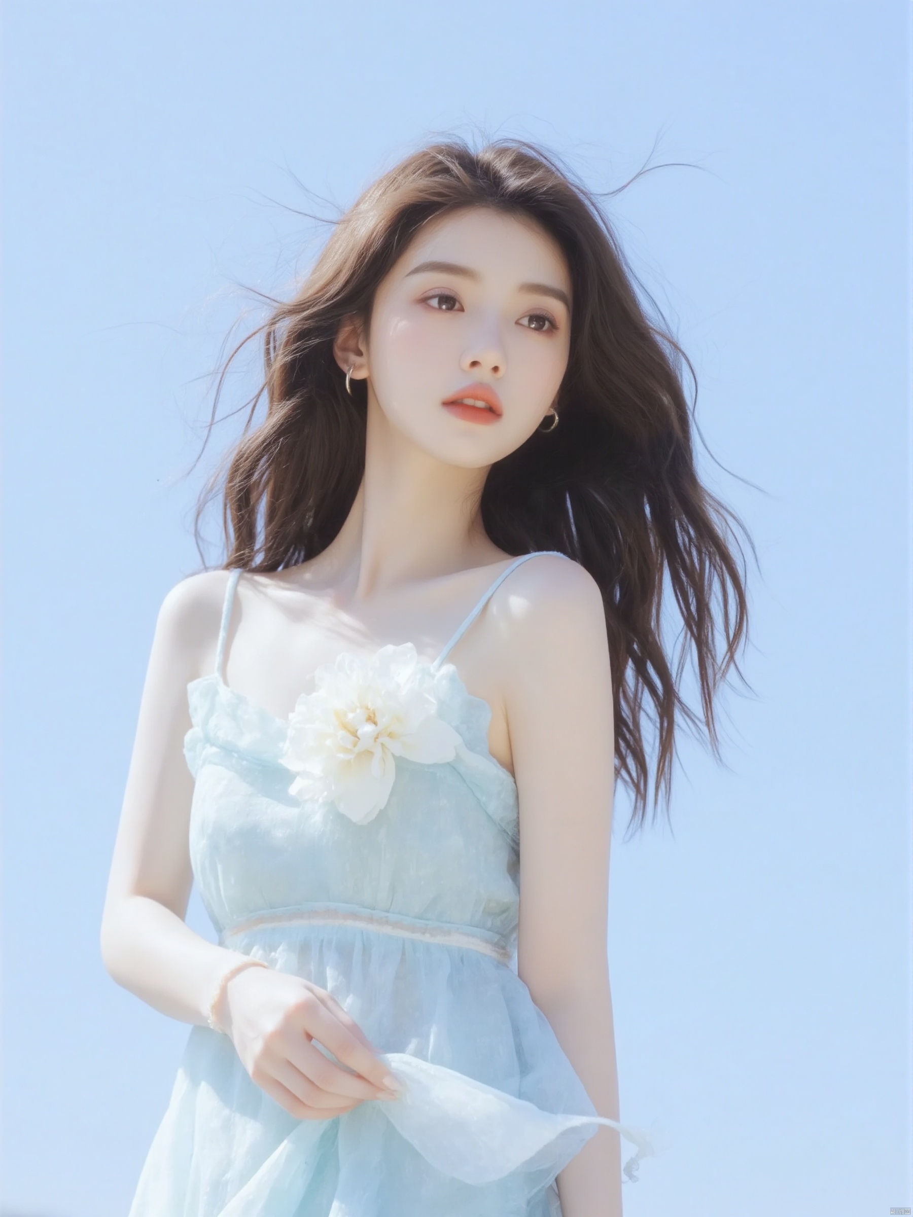 a medium-sized Asian woman with long brown hair, wearing a light blue sleeveless dress adorned with a white flower on the left side of her dress.The backdrop is a soft blue sky, creating a stark contrast to the woman's outfit.