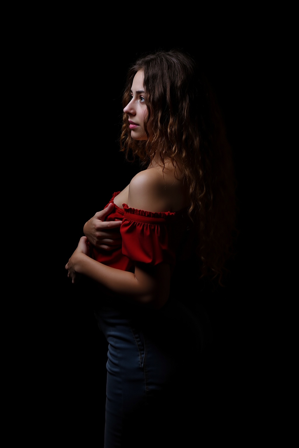 The image is a portrait of a young woman with long,  curly hair. She is wearing a red off-shoulder top and blue jeans. Her...
