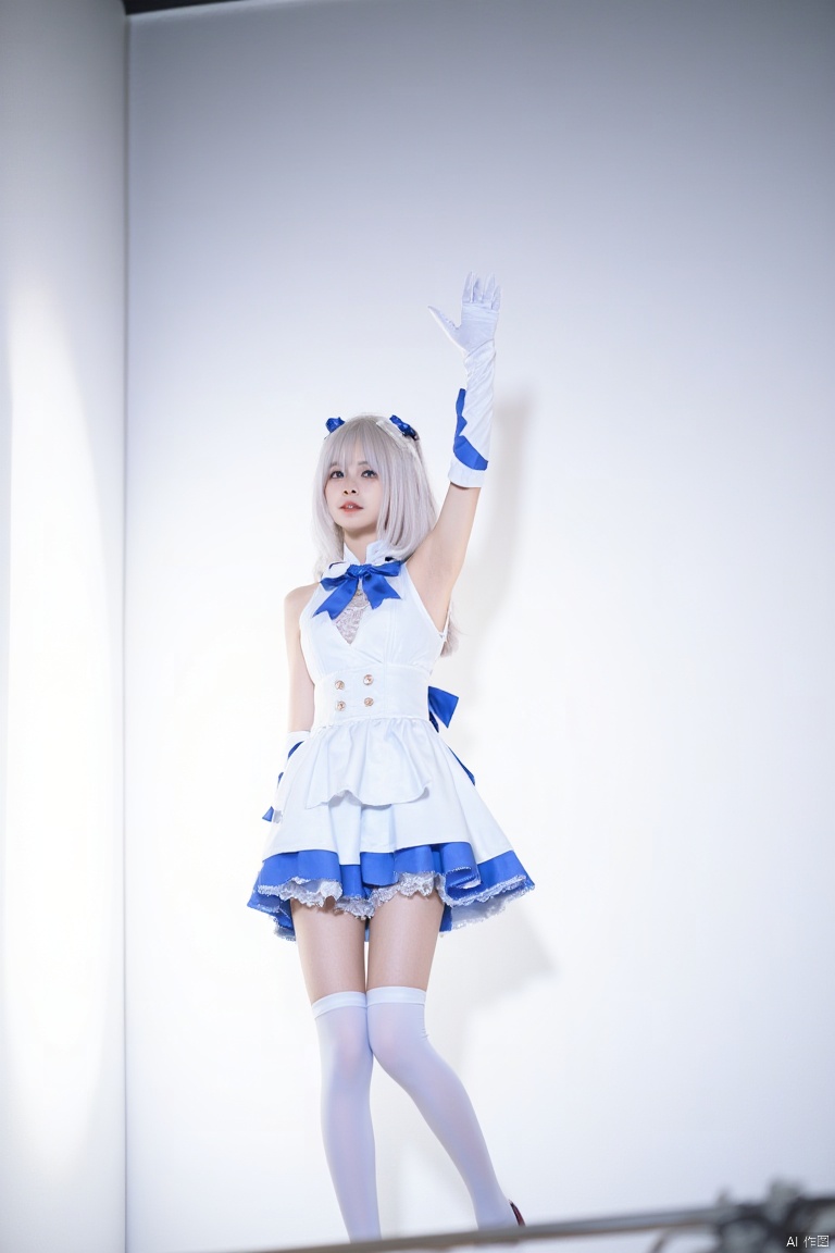 Captured from a low-angle perspective on a stage, a woman dressed in a white and blue costume, adorned with blue ribbons and white gloves. while her left hand is raised in the air. The woman's hair is adorned with a blue ribbon, adding a pop of color to the scene. The backdrop is a stark white wall, illuminated by a bright light, creating a stark contrast to the woman's costume.
