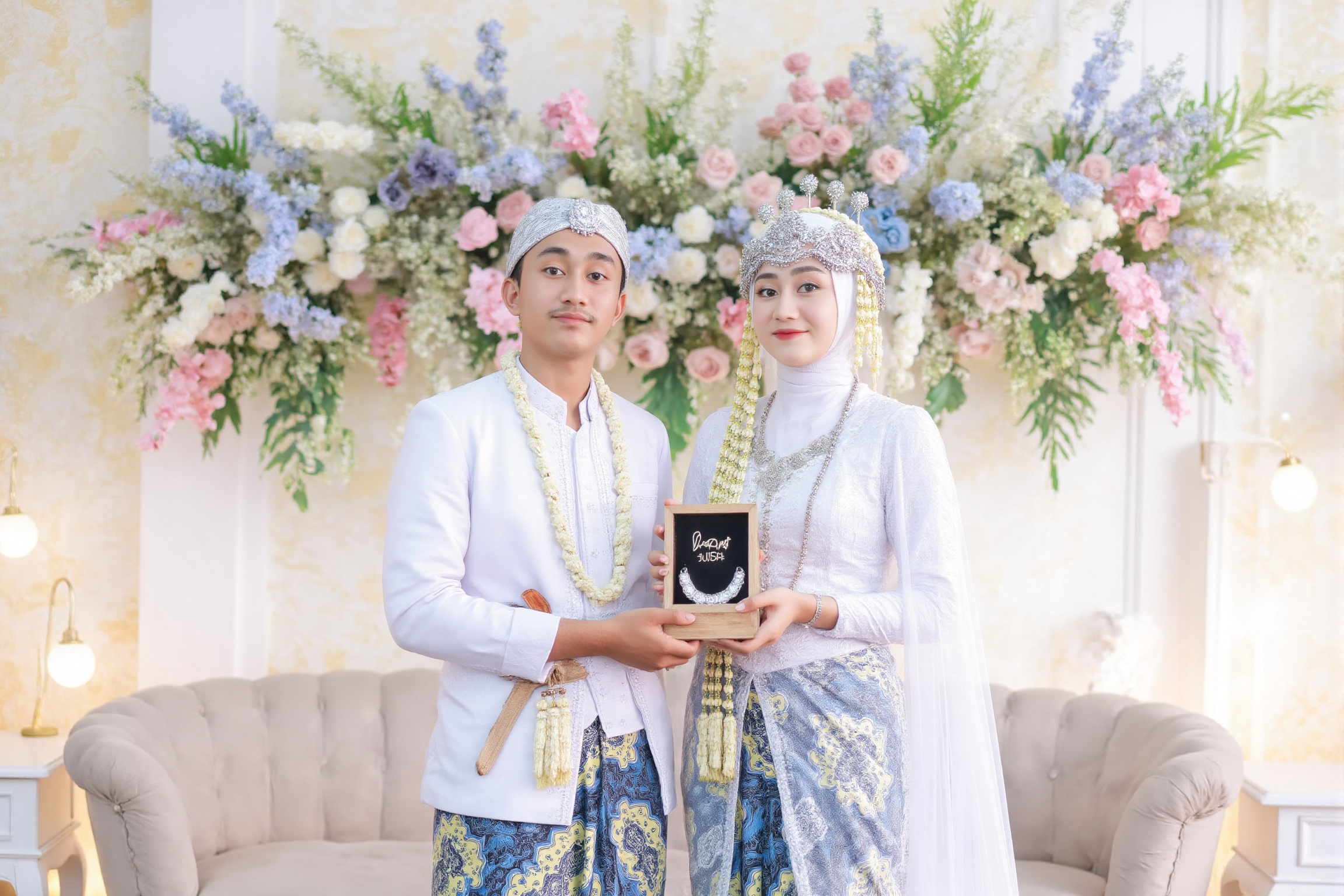 wedding photography,  the bride and groom standing in front of a wedding backdrop,  rumsyah the hijab young asian woman on...