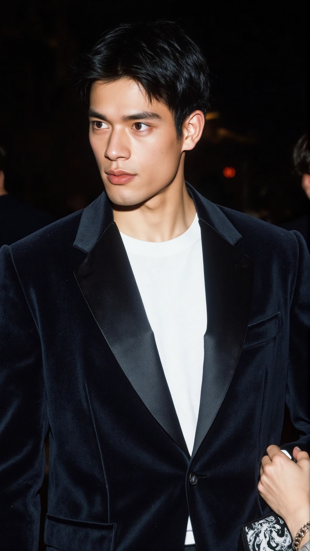 a 2000s paparazzi photo of a 18 years old handsome young man,  he is wearing a black velvet tuxedo by Gucci by Tom Ford. H...