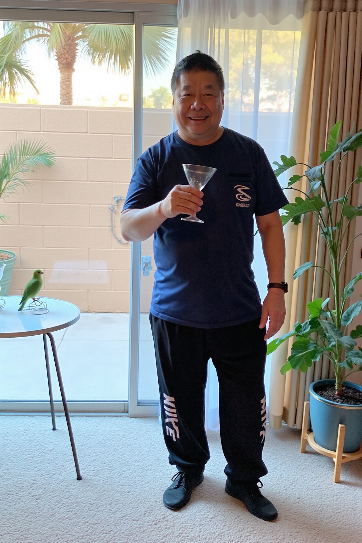 The image is a high-resolution photograph of p4ull1m,  a middle-aged man standing indoors near a large sliding glass door...