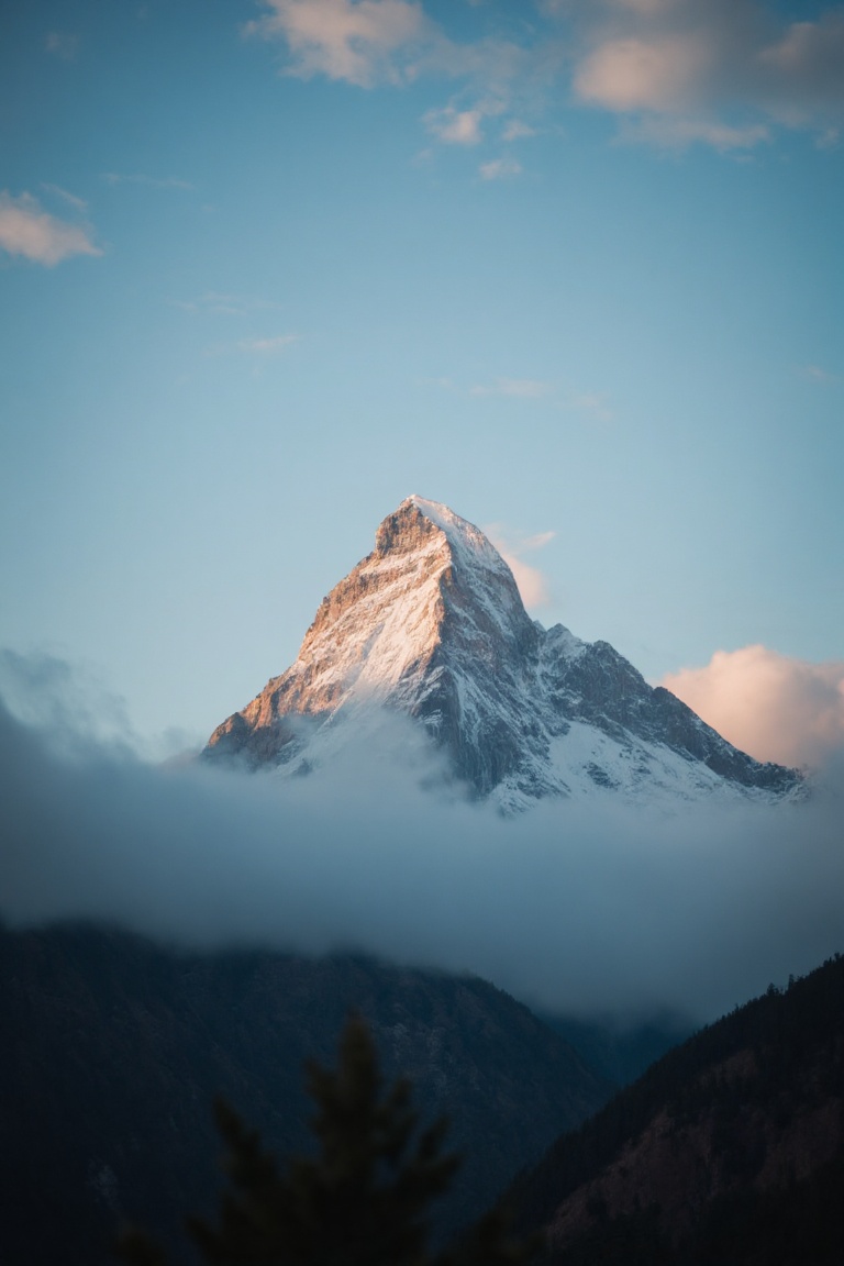 A serene photograph captures a majestic mountain peak at dawn,  with soft golden light illuminating the snow-capped summit...