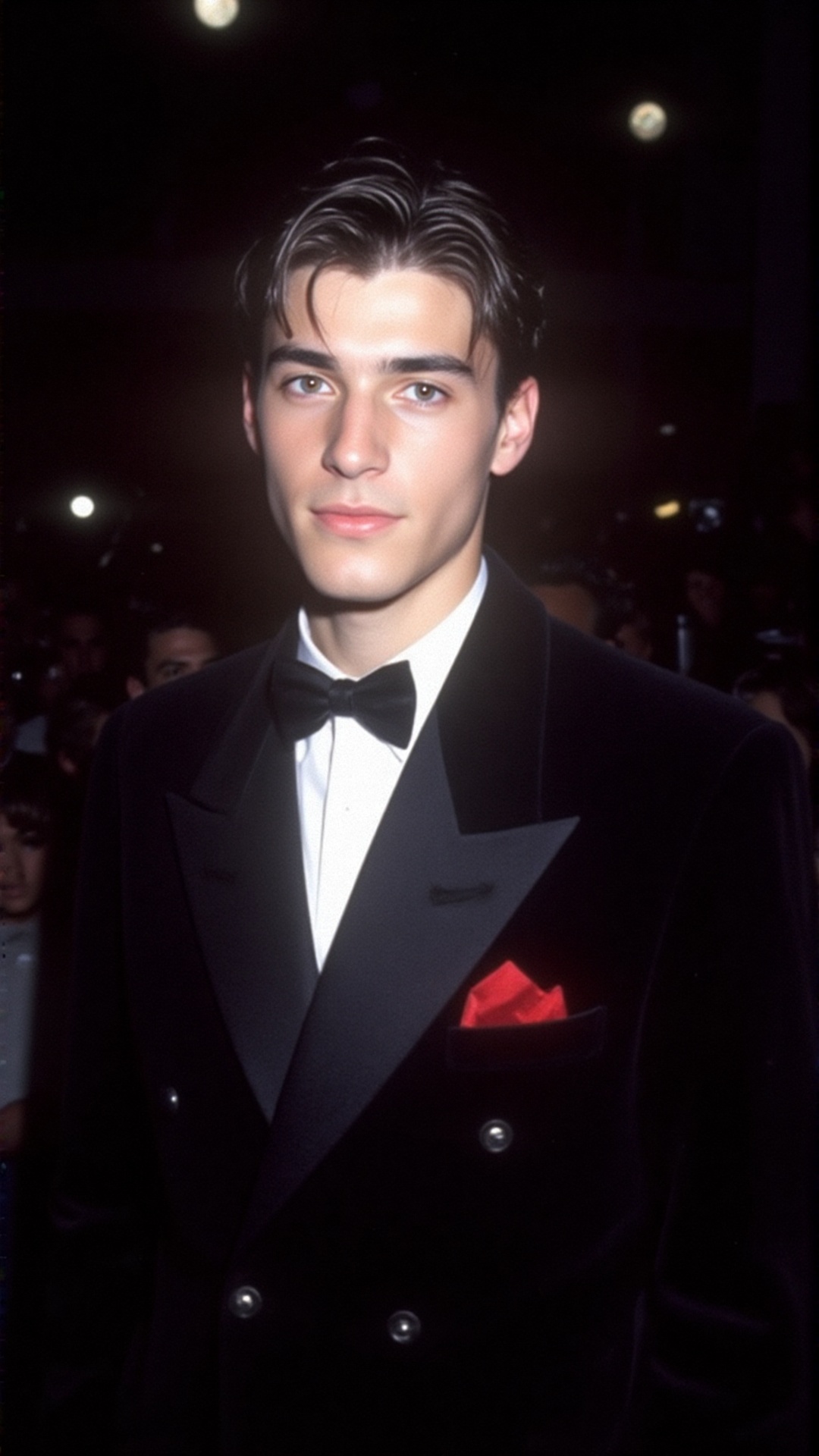 a 2000s paparazzi photo of a 18 years old handsome young man,  he is wearing a black velvet tuxedo by Gucci by Tom Ford. H...