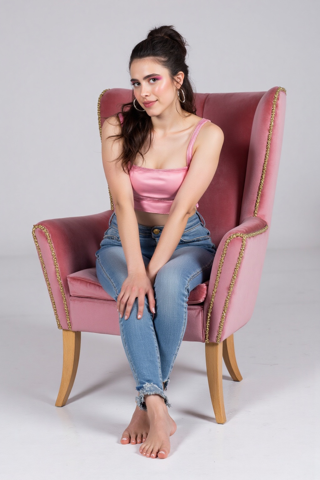 A photograph of a young woman with long dark hair tied up in a ponytail,  wearing a sleek pink crop top and jeans pants. H...